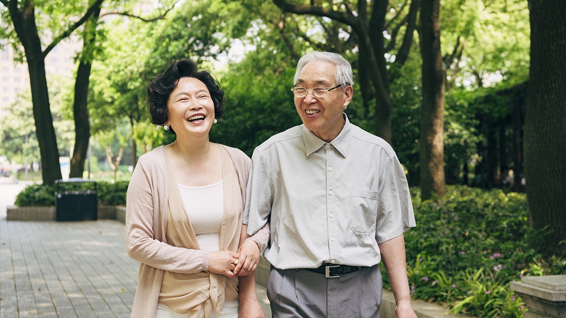 older couple walking and smiling