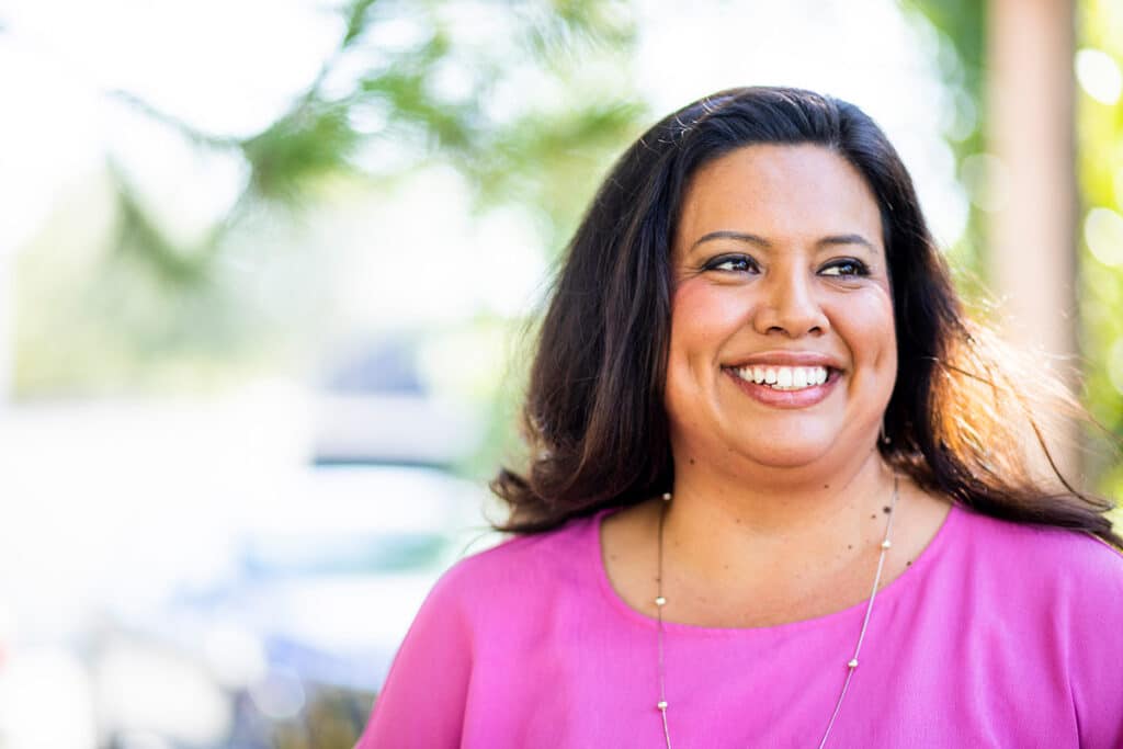 Lady in purple clothes smiling